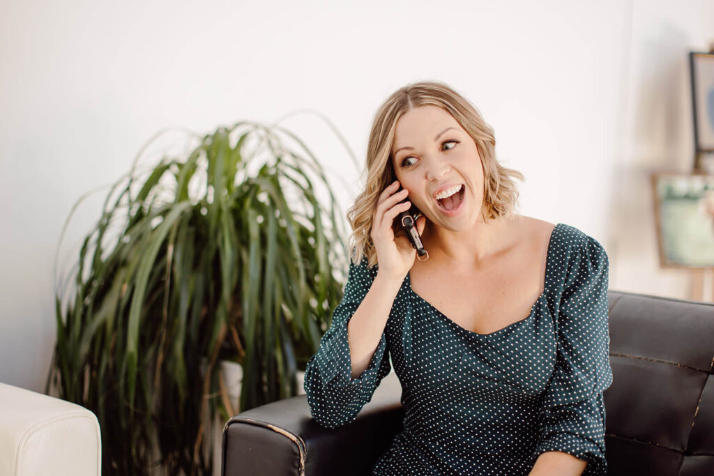 Woman entrepreneur talking on phone to business team