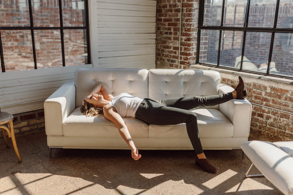 Wedding business owner laying on couch relaxing